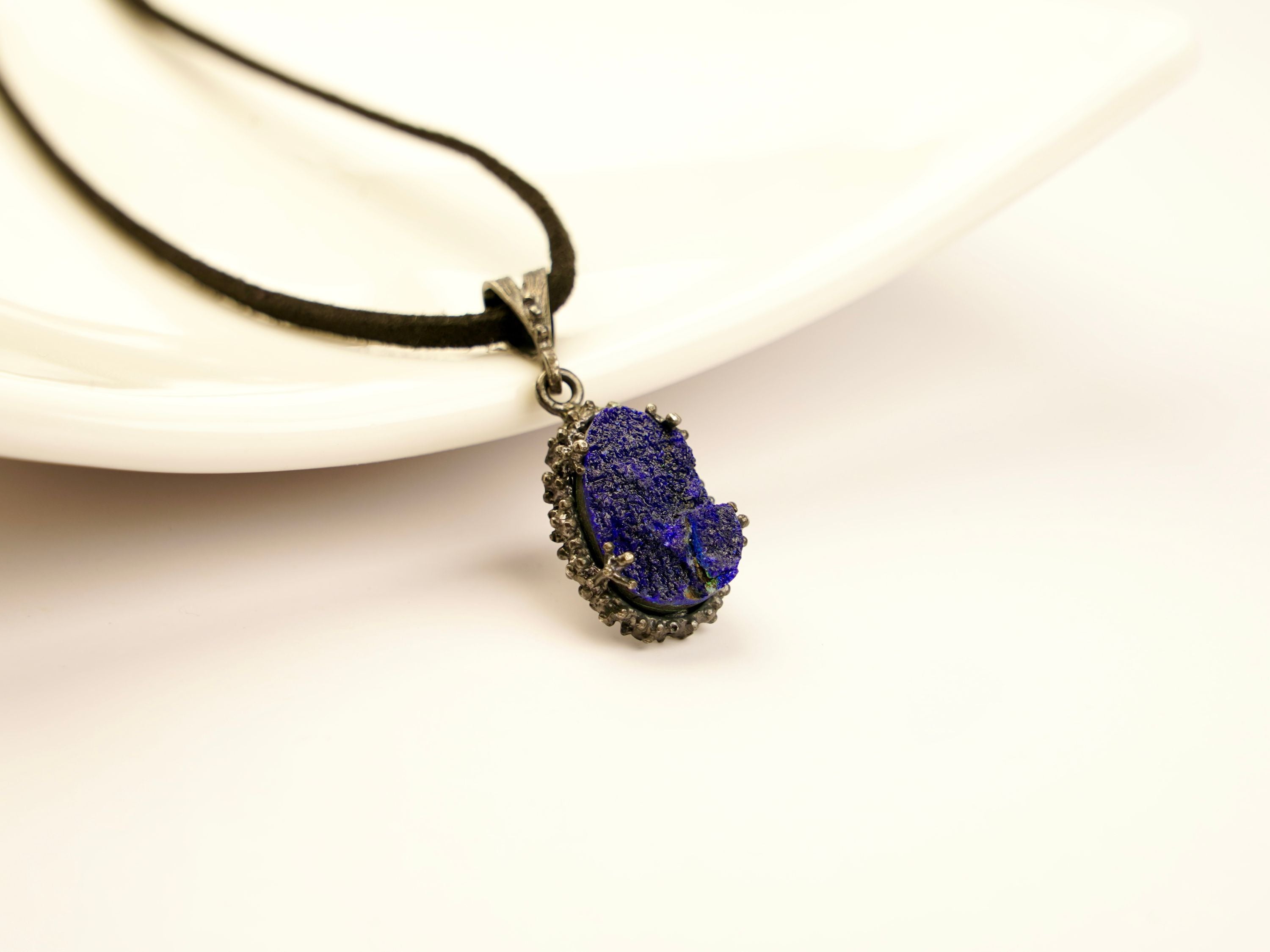 lapis lazuli pendant necklace on display, raw blue crystal sterling silver jewelry