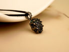 Unique Obsidian gemstone necklace in sterling silver setting, professional product photography for AKRA jewelry.