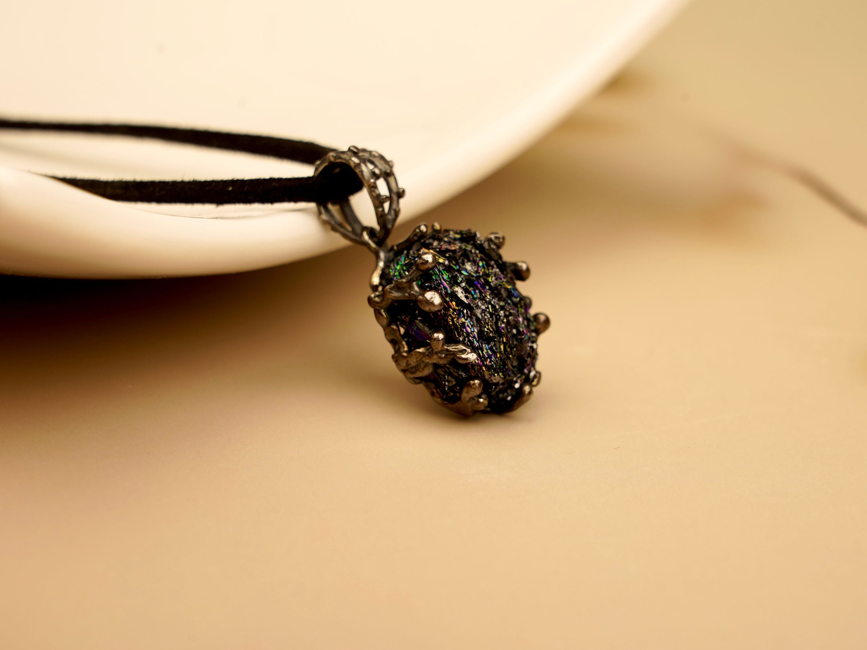 Unique Obsidian gemstone necklace in sterling silver setting, professional product photography for AKRA jewelry.