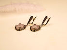 rose quartz earrings on display, elegant pink gemstone silver drop earrings