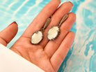 Moonstone drop earrings on hand size reference white gemstone silver earrings