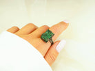 Statement raw malachite stone ring worn on finger showing large rectangular gemstone size