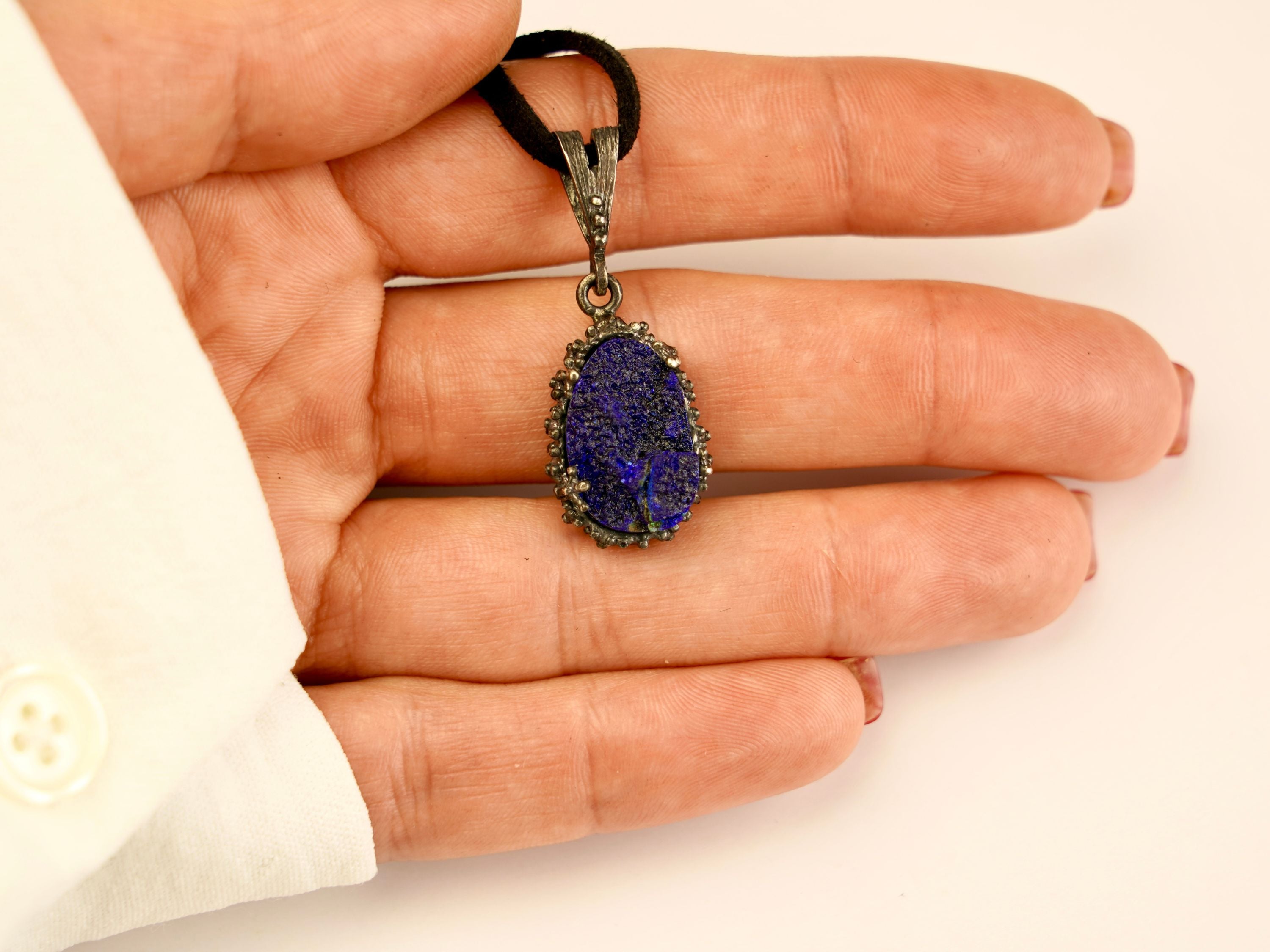 lapis lazuli pendant necklace on hand, size reference raw blue gemstone jewelry