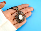 moonstone statement necklace on hand, size reference large artistic pendant