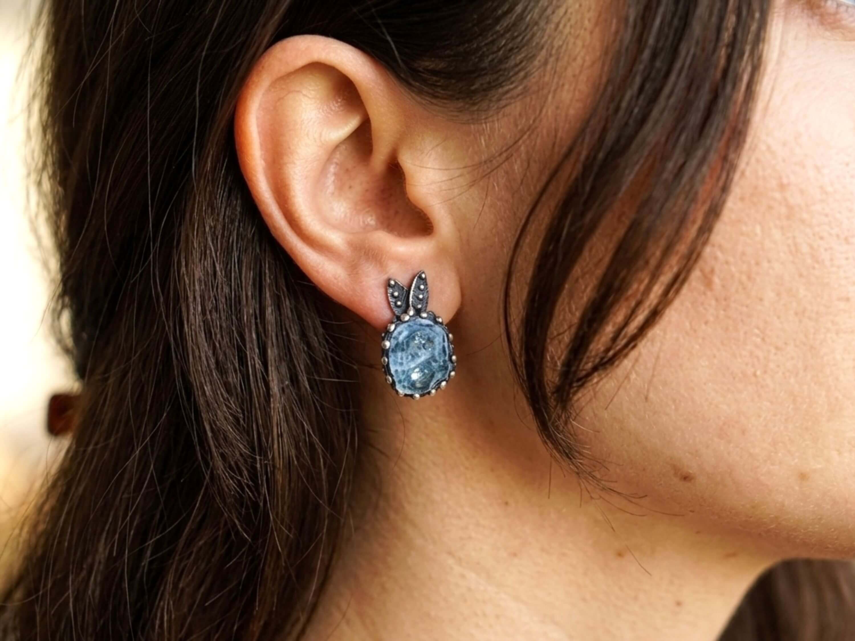 Elegant aquamarine gemstone earrings worn by a model showcasing the vibrant blue color