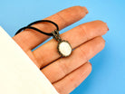 moonstone pendant necklace on hand, size reference white gemstone jewelry