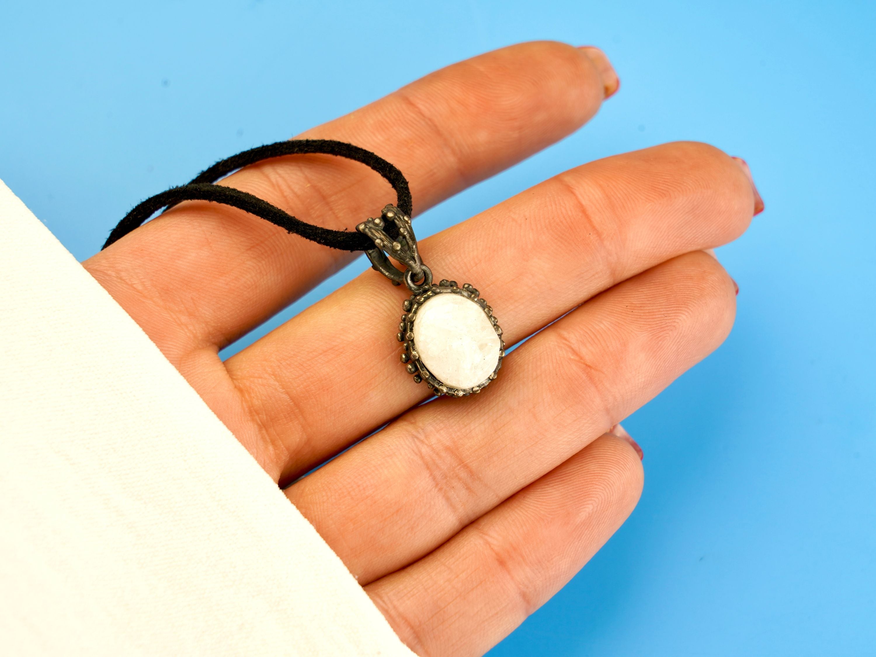 moonstone pendant necklace on hand, size reference white gemstone jewelry