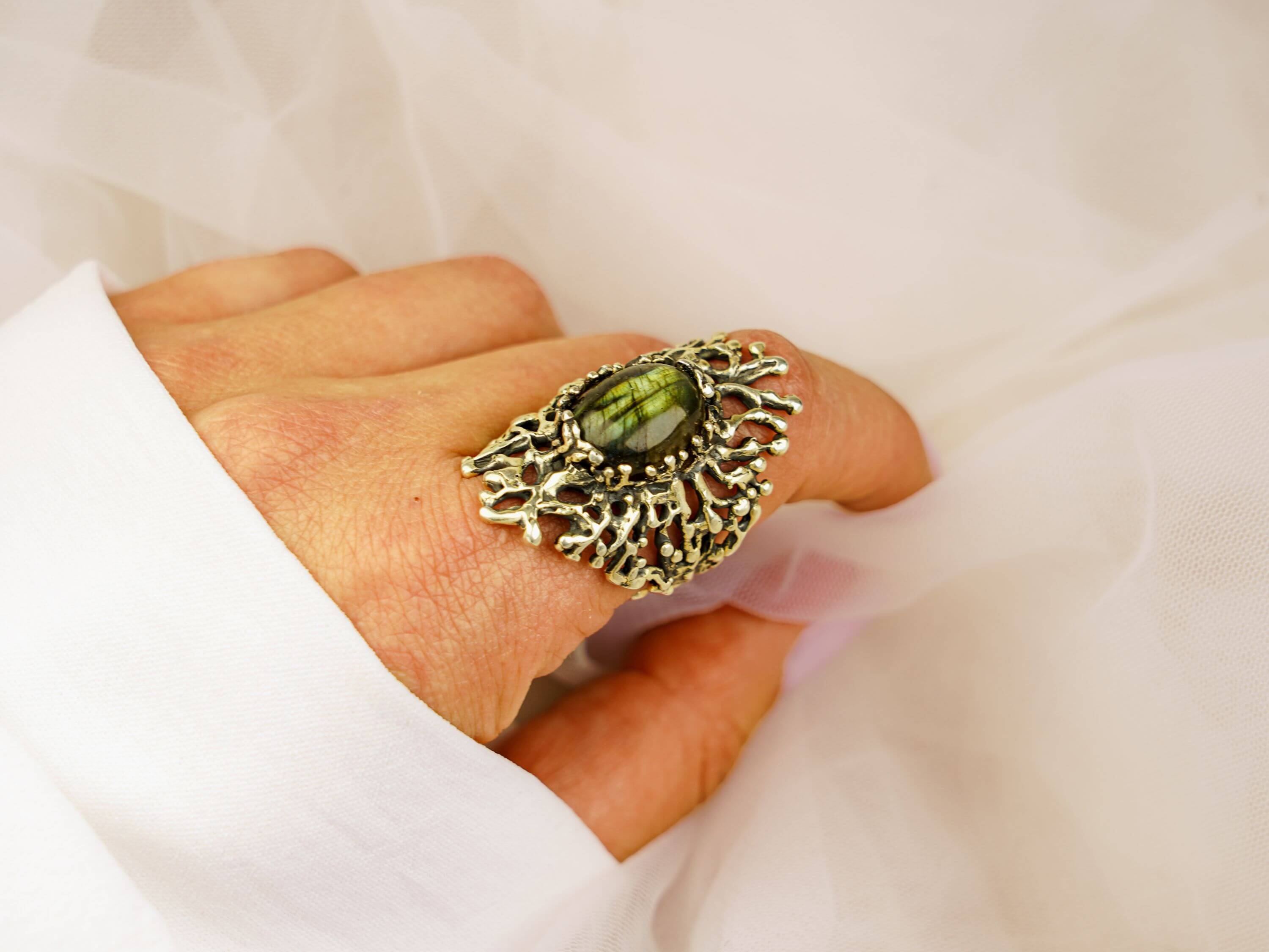 Statement gothic labradorite ring worn on hand showcasing the blue-green gemstone glow