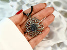 tourmaline pendant necklace on hand, size reference dark gemstone jewelry