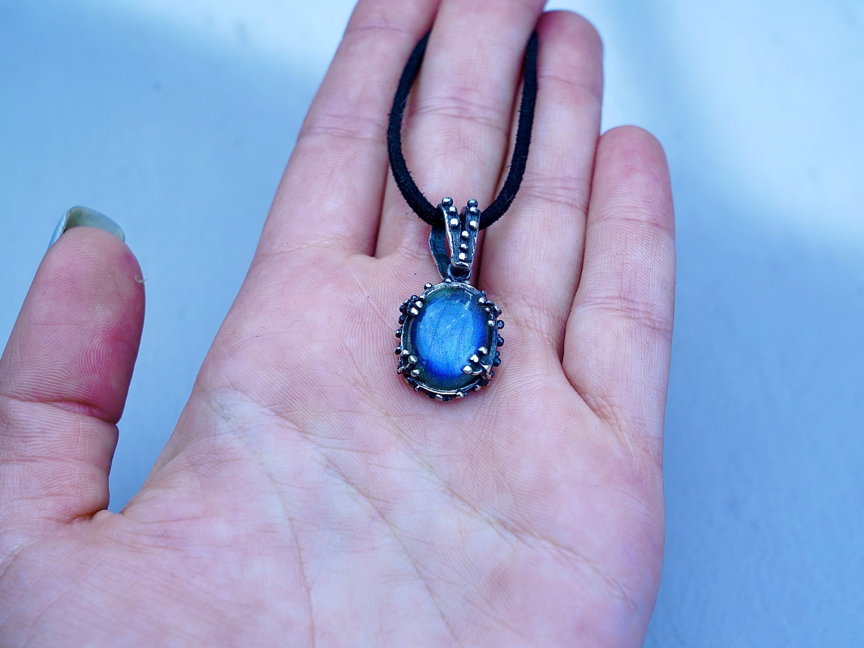 Labradorite pendant on hand size reference blue flash gemstone necklace