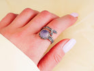 Ethereal rose quartz ring worn on hand showing the delicate pink gemstone and silver branch wrap