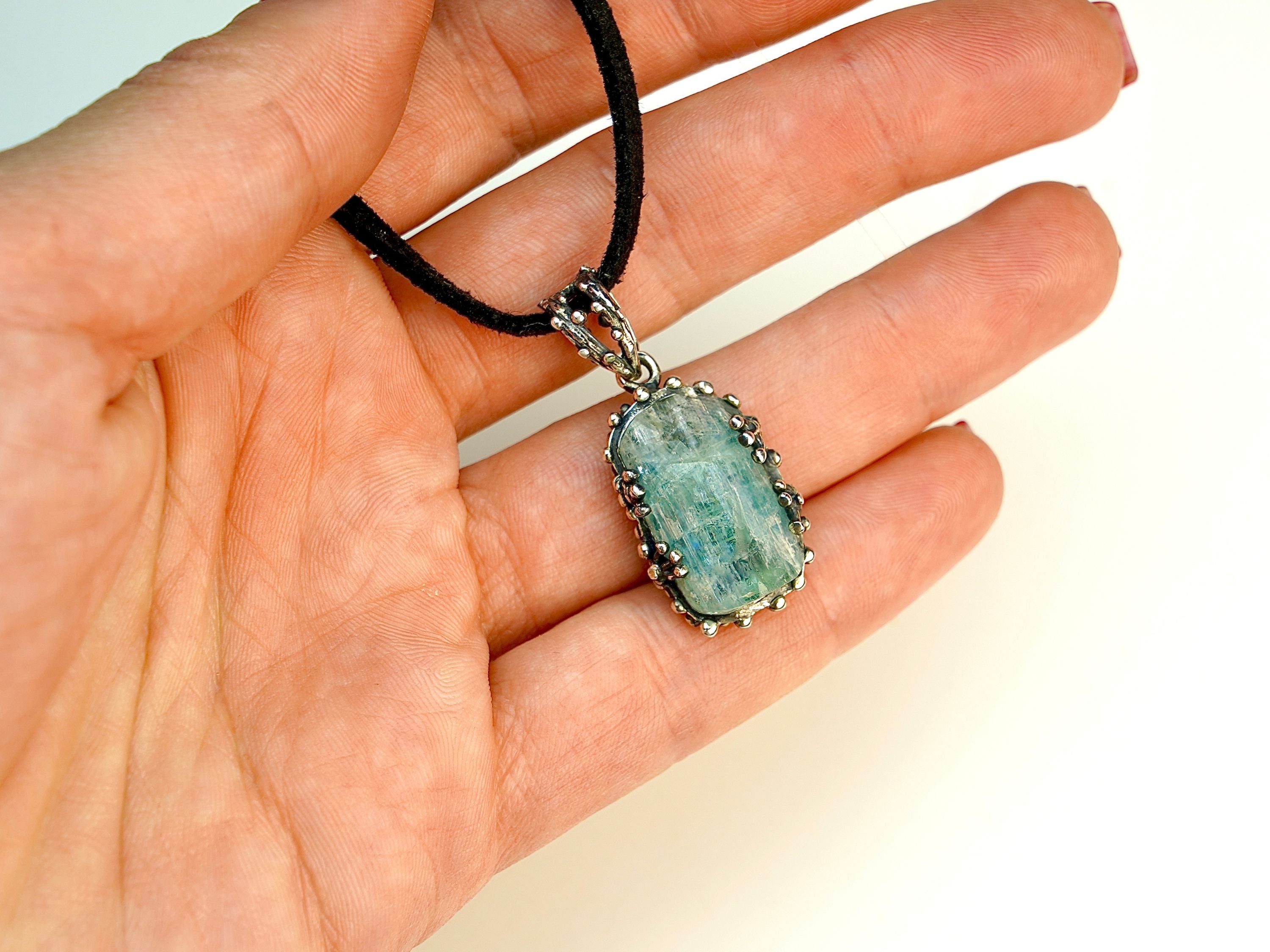 Aquamarine pendant on hand size reference raw blue gemstone silver necklace