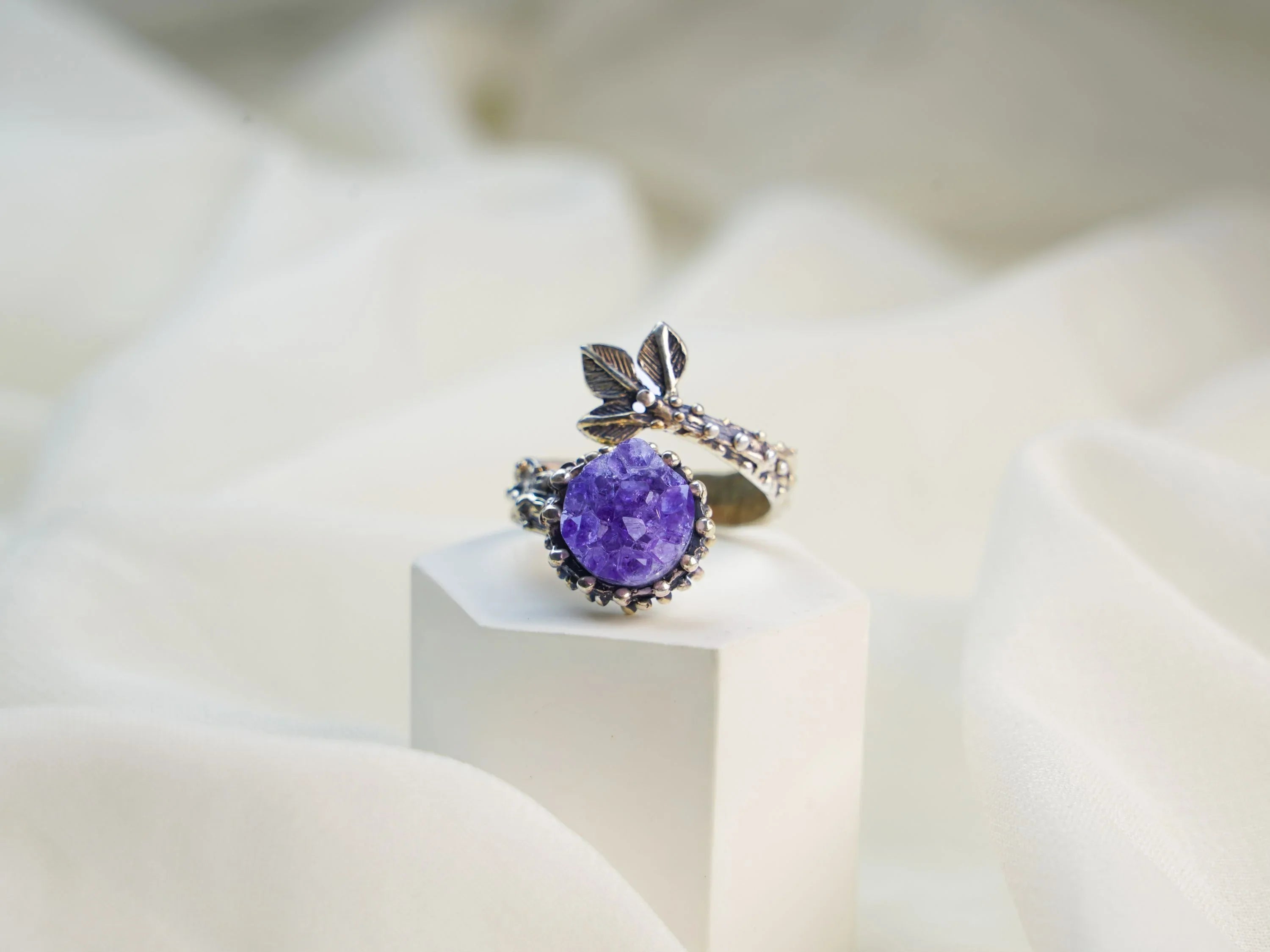 Amethyst ring on display minimalist jewelry aesthetic purple gemstone