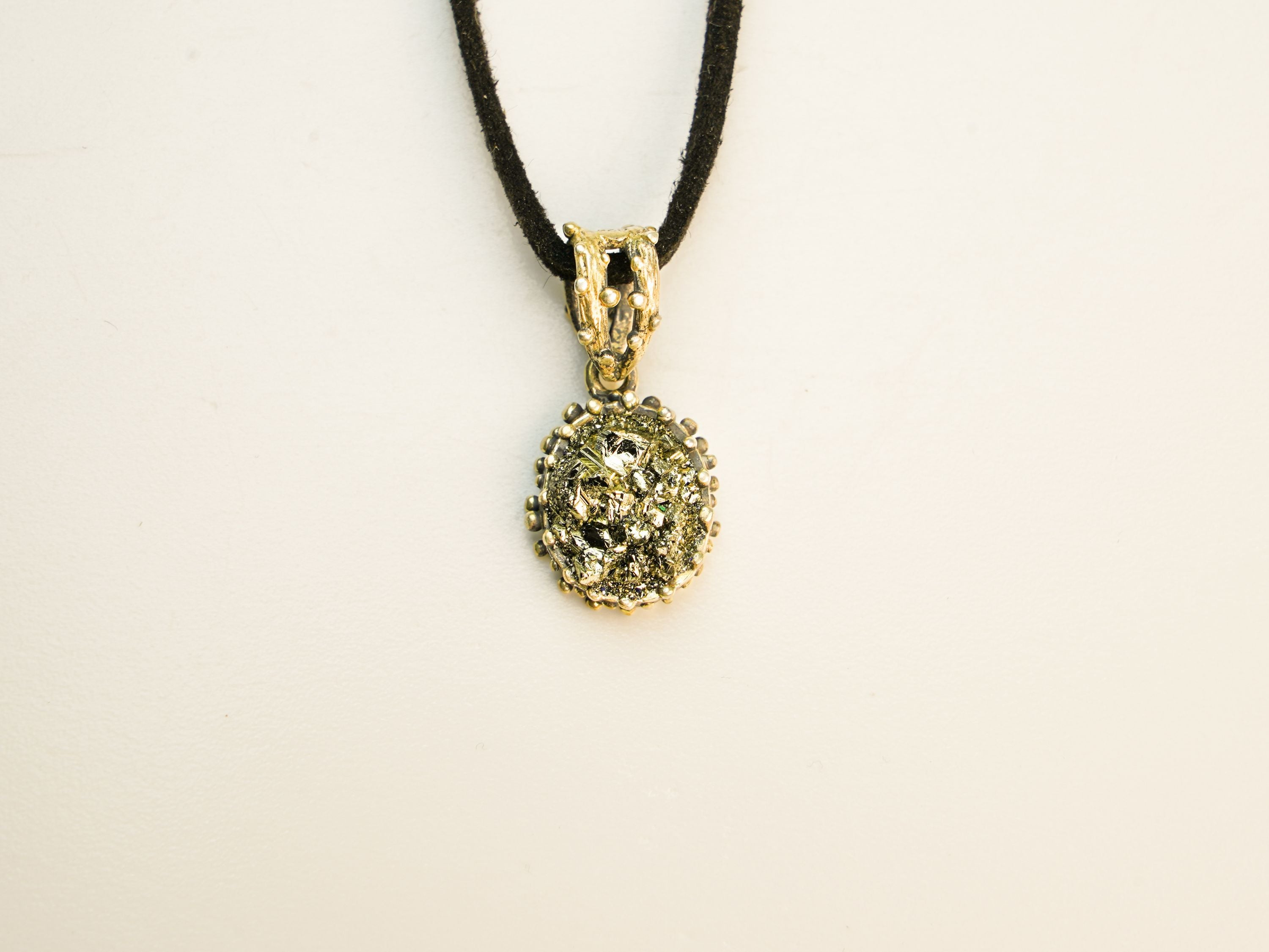 close up pyrite pendant natural gold crystal texture detail