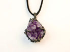 close up raw amethyst crystal pendant, natural purple gemstone texture detail