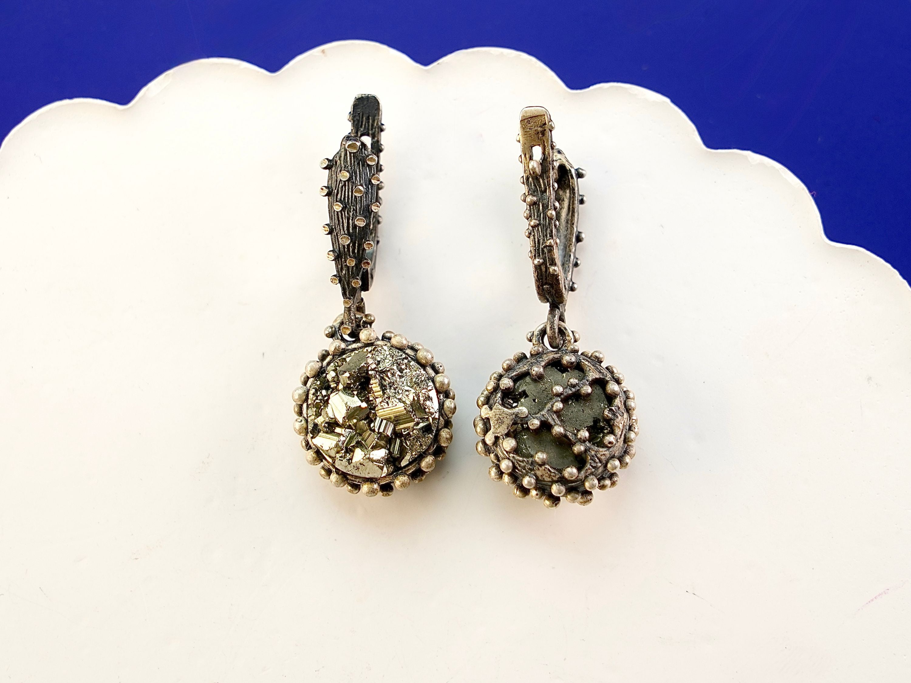 Close up pyrite earrings metallic gold crystal cluster detail silver setting