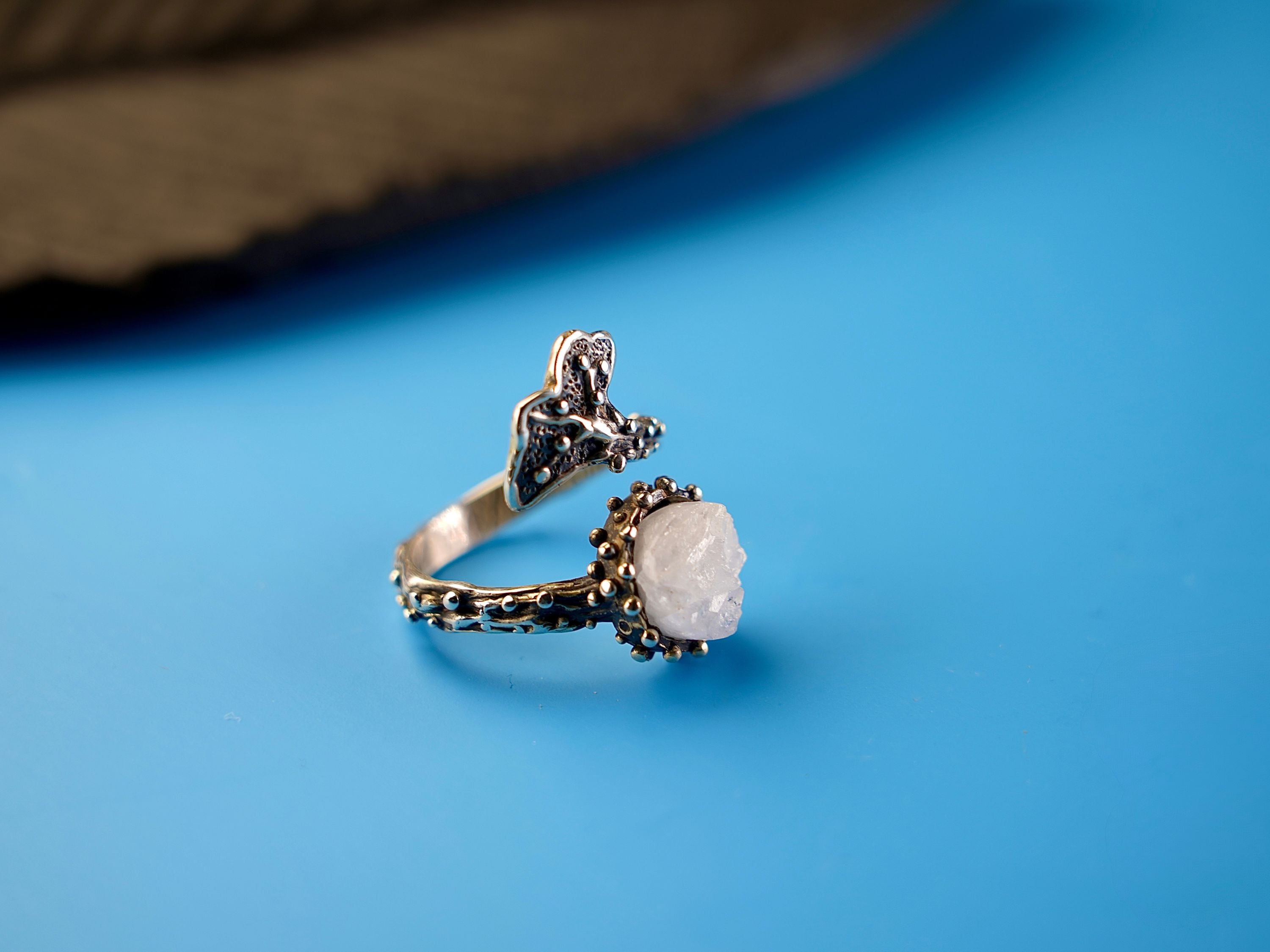 Close up moonstone smooth surface soft glow crystal detail adjustable sterling silver ring