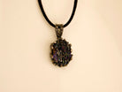 Front view of a gothic-style Obsidian necklace with a dark silver setting and an adjustable black cord
