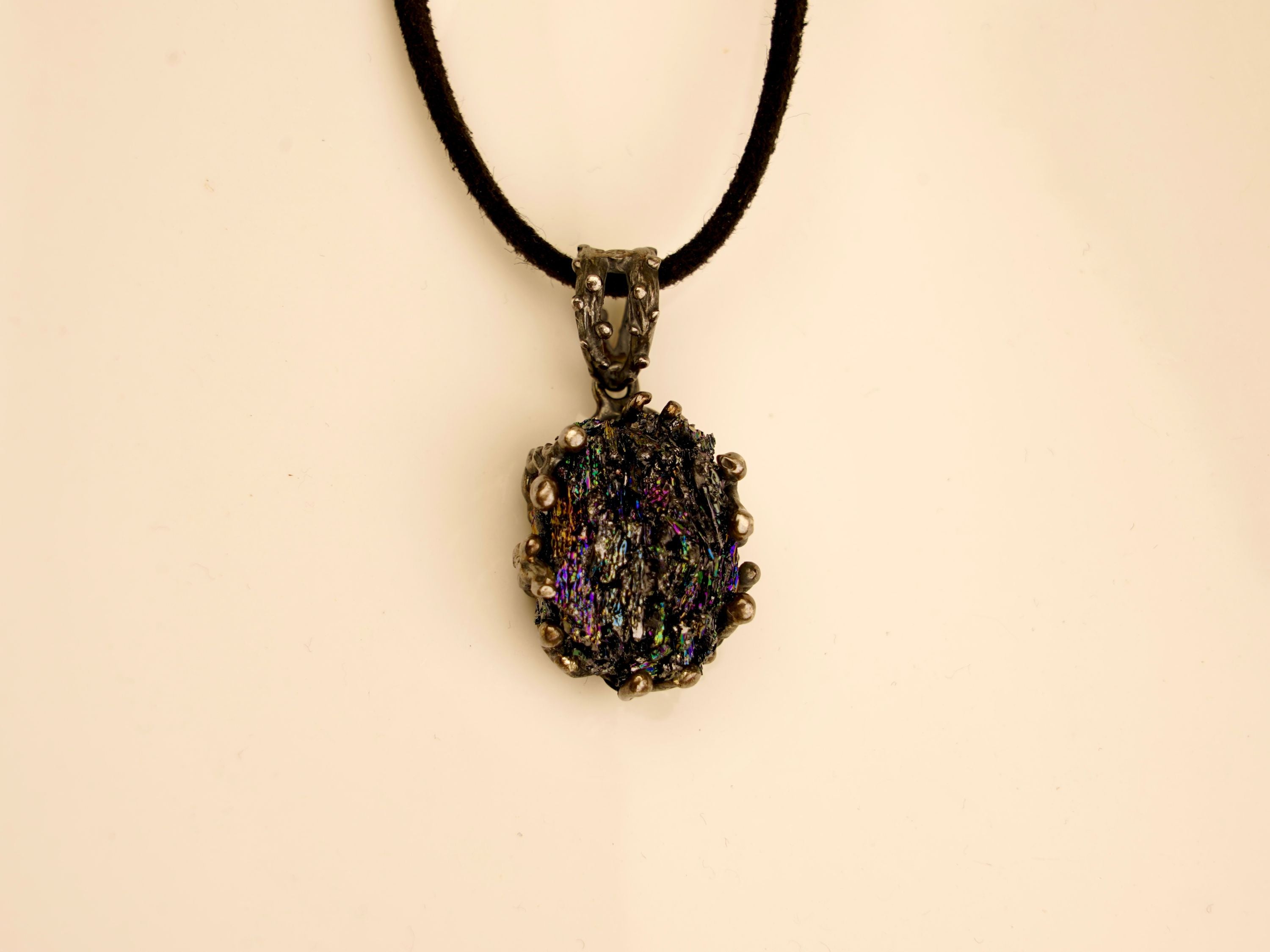 Front view of a gothic-style Obsidian necklace with a dark silver setting and an adjustable black cord