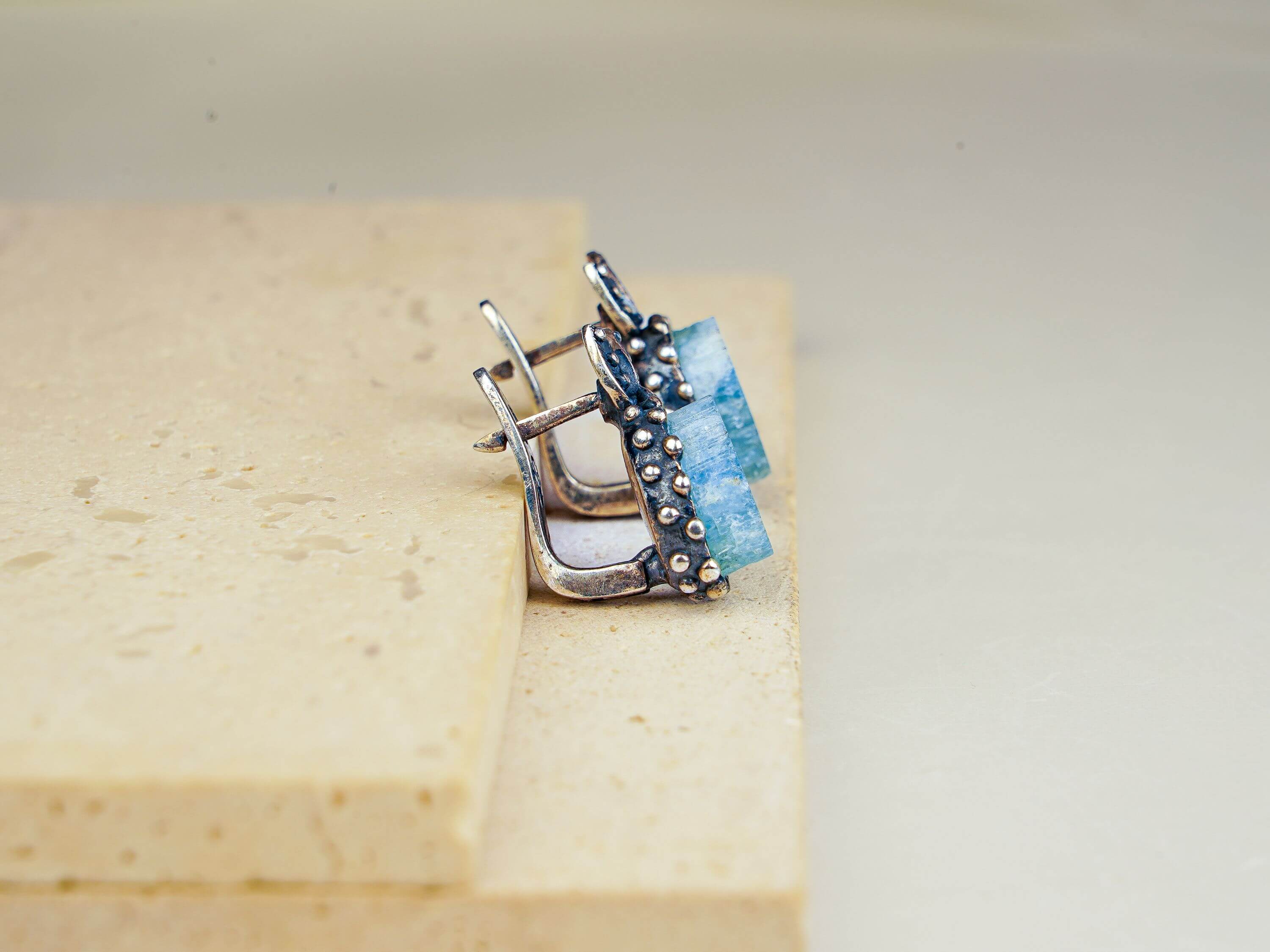 Macro shot of natural raw-cut aquamarine stones highlighting the unique crystalline texture