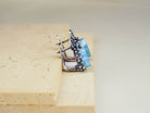 Macro shot of natural raw-cut aquamarine stones highlighting the unique crystalline texture