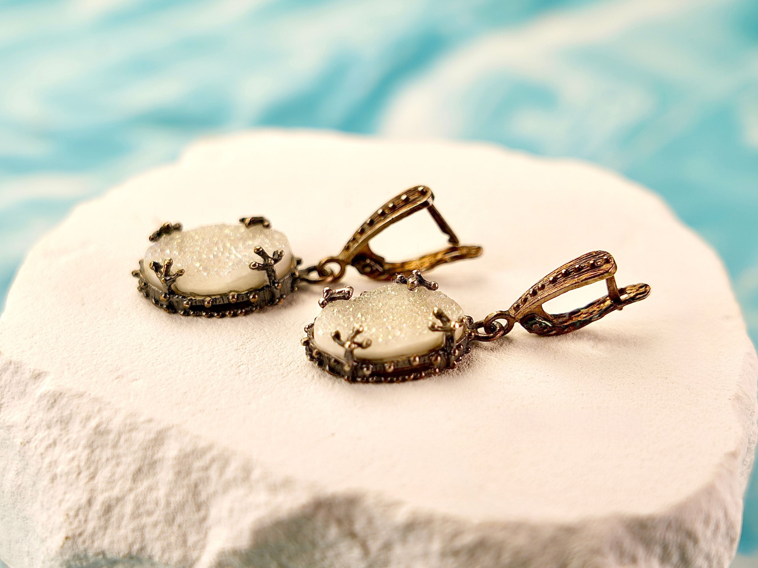 Close up moonstone drop earrings glowing white stone detail silver setting