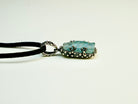 Close up aquamarine crystal raw texture blue gemstone detail sterling silver pendant