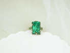 Close-up of natural green malachite texture and ornate handcrafted silver ring frame