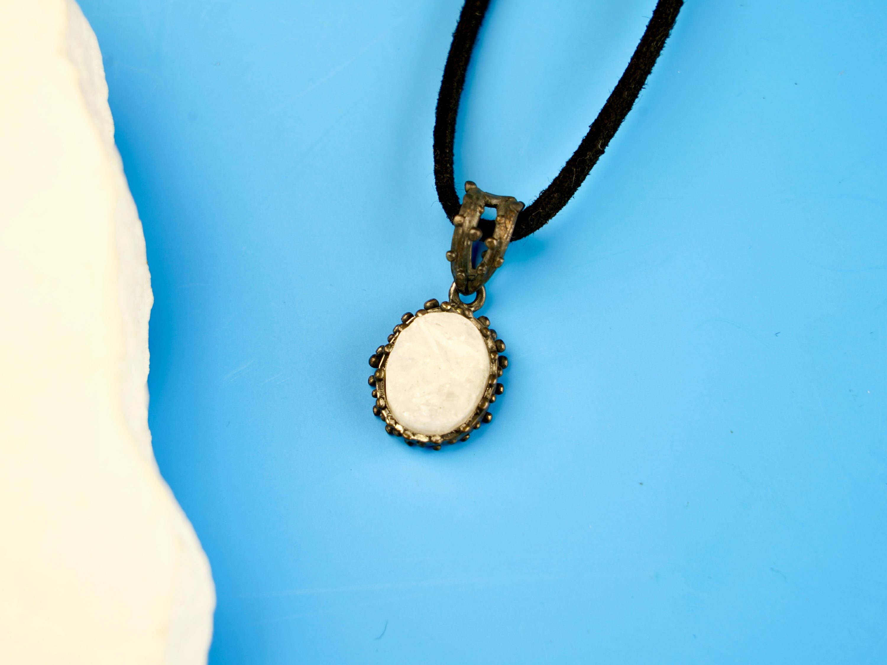 close up moonstone pendant, natural white gemstone soft glow detail