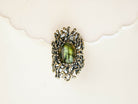 Macro view of a natural iridescent labradorite stone in a detailed vintage silver frame
