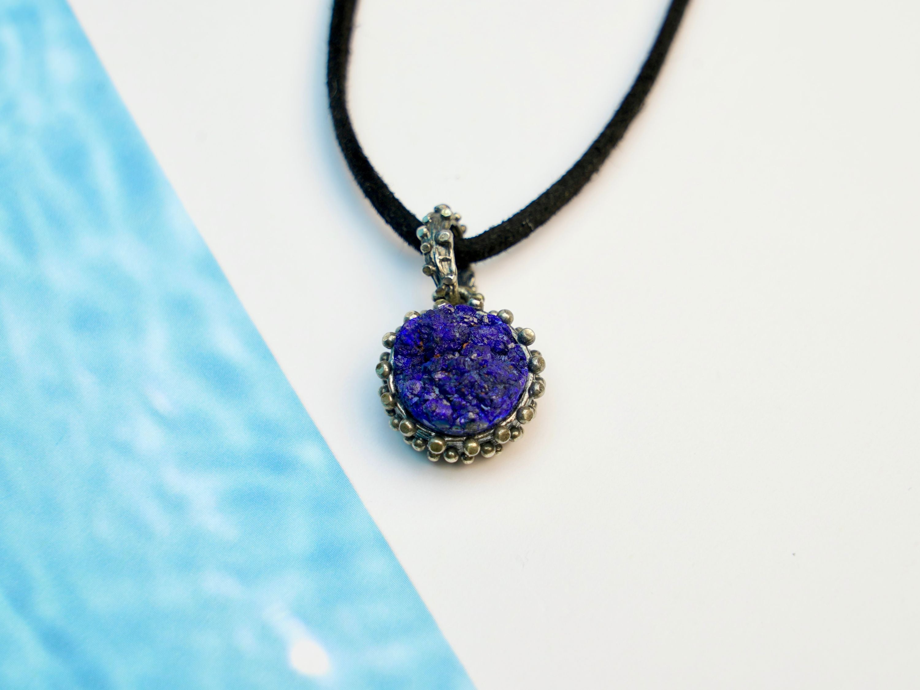 close up lapis lazuli pendant, smooth blue gemstone refined detail