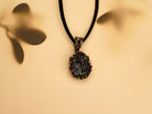 Detail shot of the Obsidian necklace on a textured stone surface, perfect for gothic and alternative fashion styles