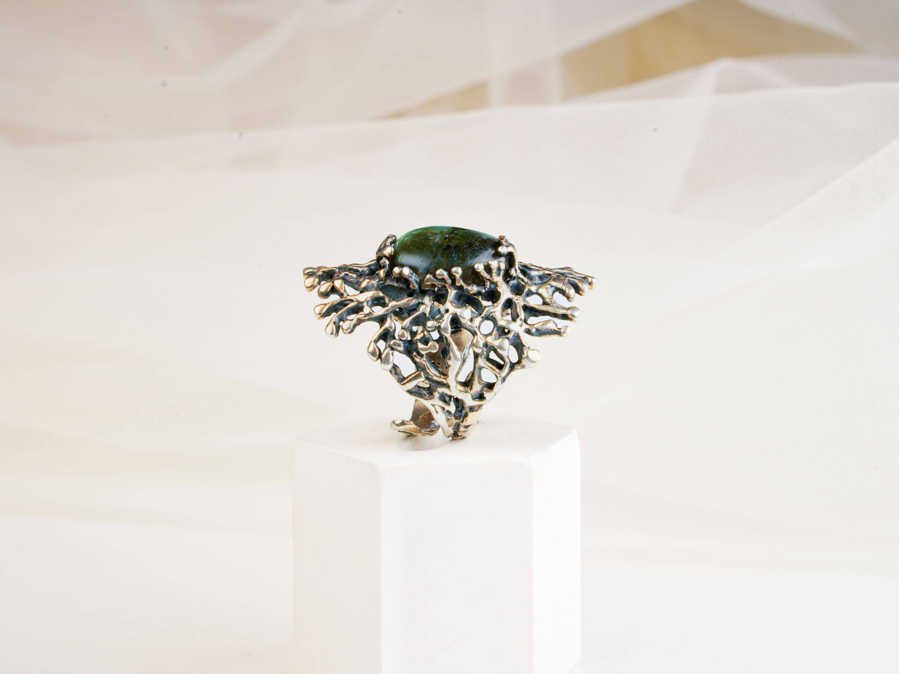 Side view of the high-set gothic labradorite ring showing the intricate silver branch-like texture
