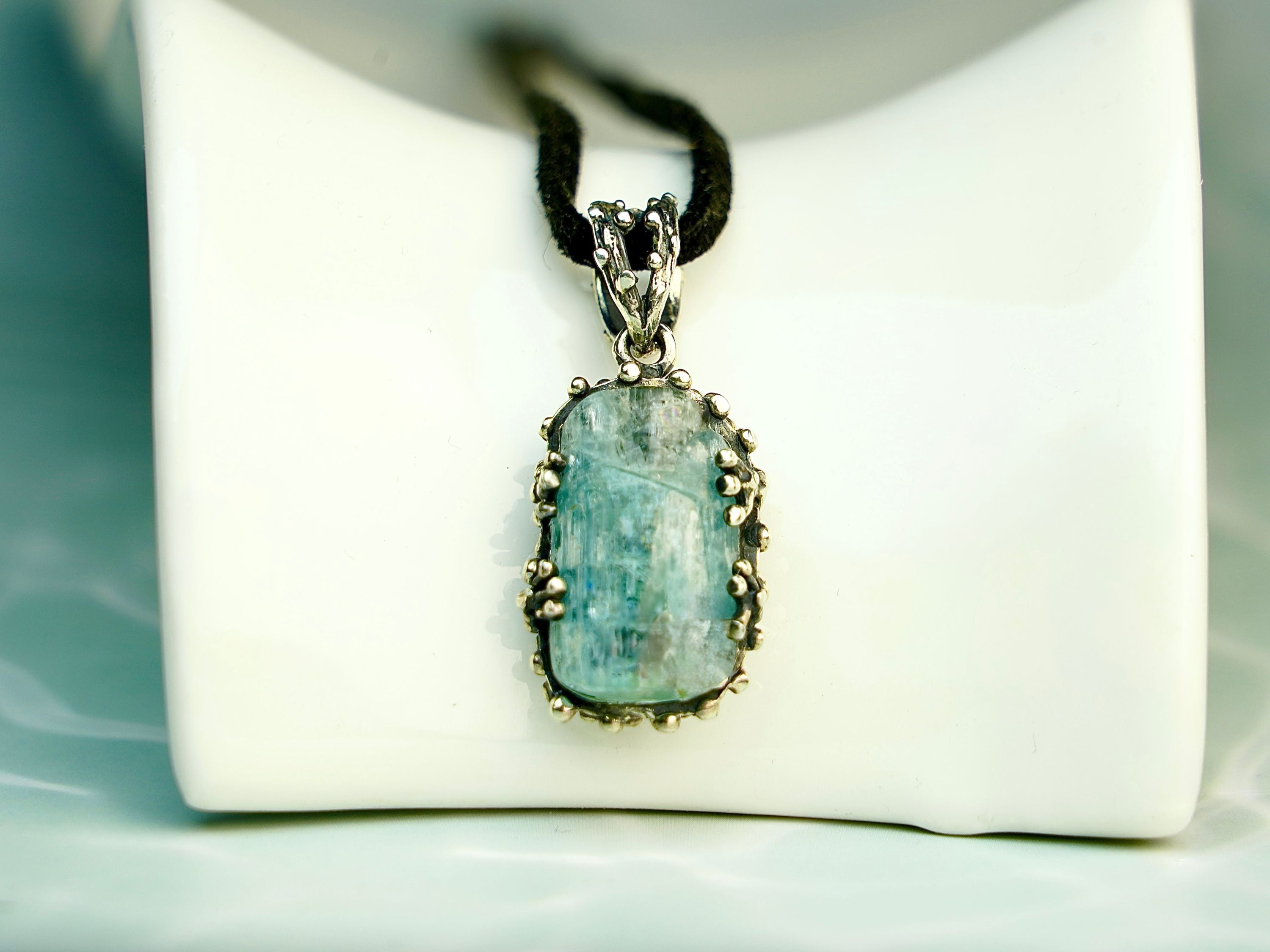 Clean front view aquamarine necklace raw blue crystal silver pendant minimal composition