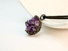 amethyst crystal pendant angled view, purple gemstone jewelry aesthetic