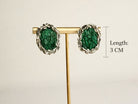 Angle view malachite earrings green stone silver earrings artistic composition