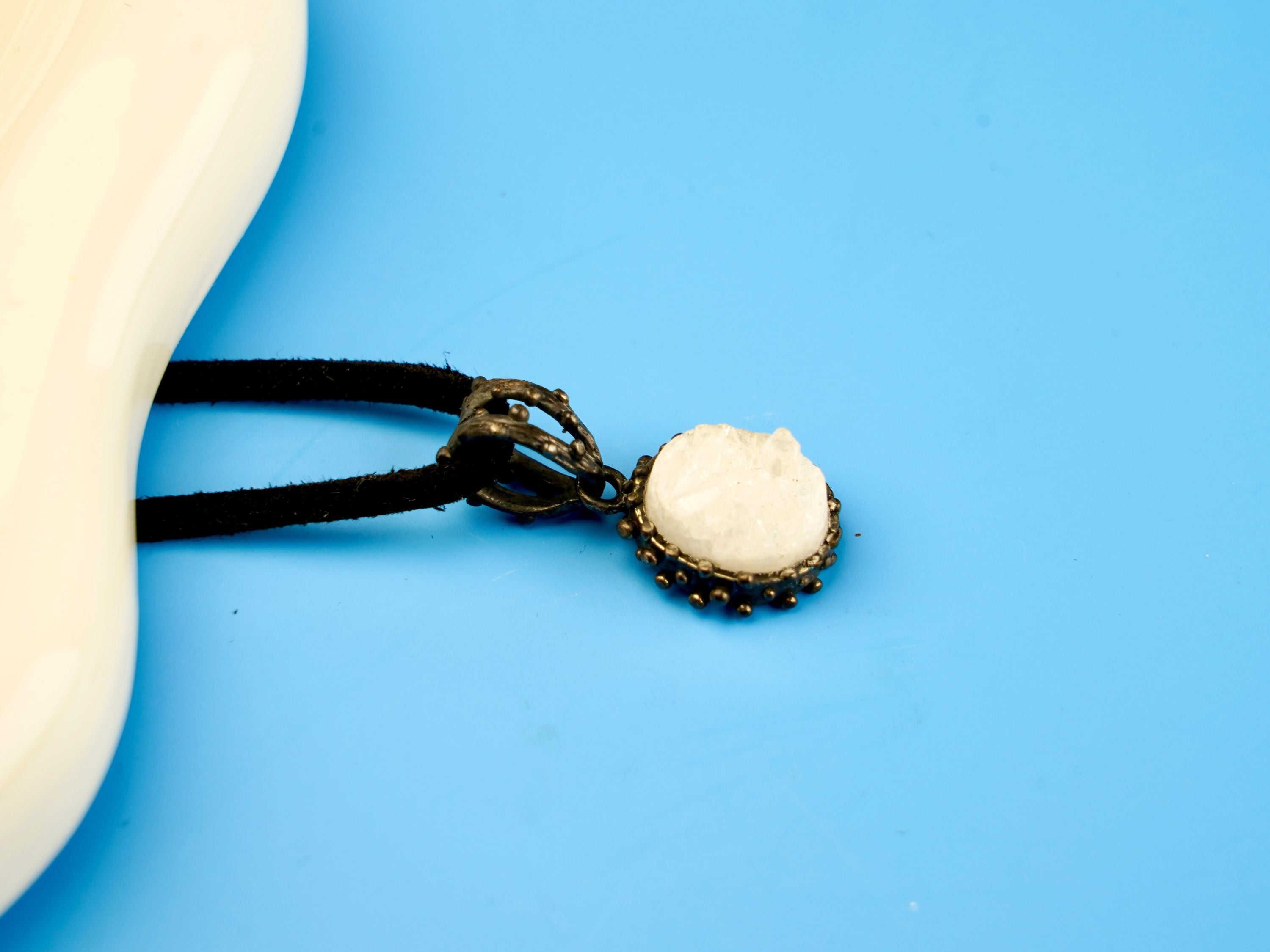 moonstone pendant angled view, white gemstone elegant jewelry aesthetic
