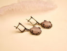 rose quartz earrings angled view, feminine pink gemstone jewelry