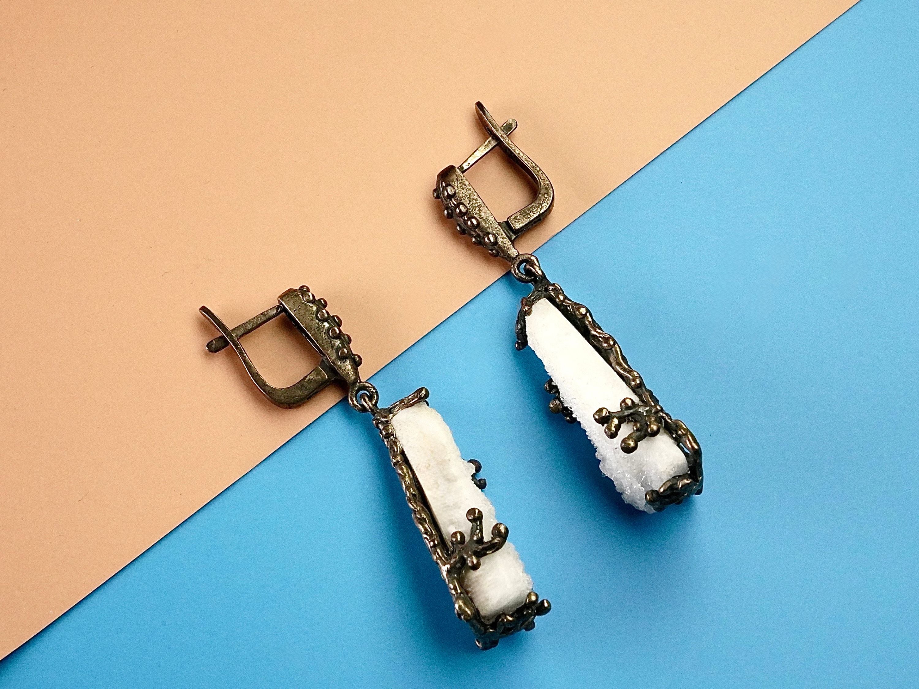 Angle view moonstone earrings raw crystal silver drop earrings perspective