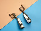 Angle view moonstone earrings raw crystal silver drop earrings perspective