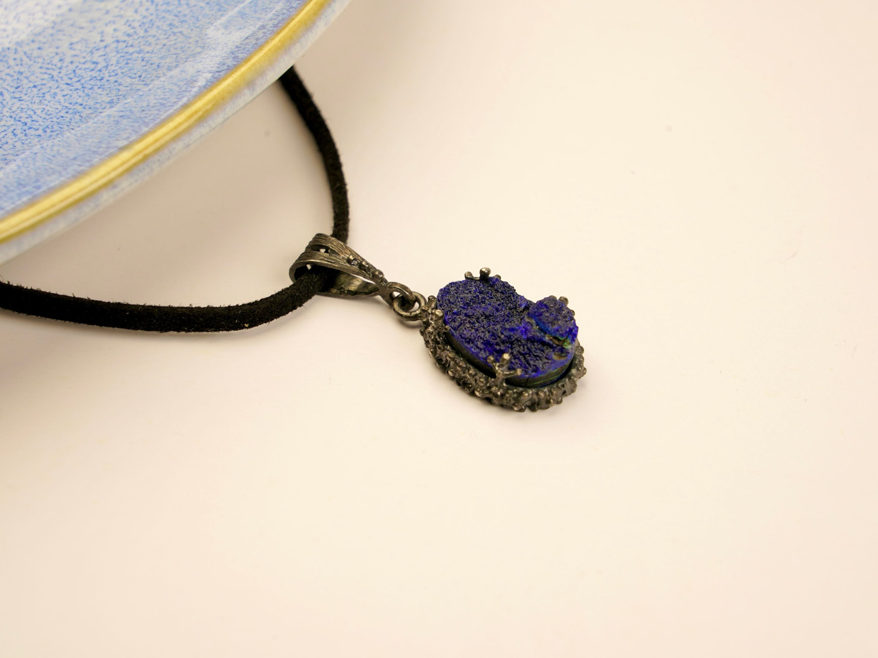 lapis lazuli pendant angled view, deep blue gemstone artistic jewelry