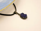 lapis lazuli pendant angled view, deep blue gemstone artistic jewelry