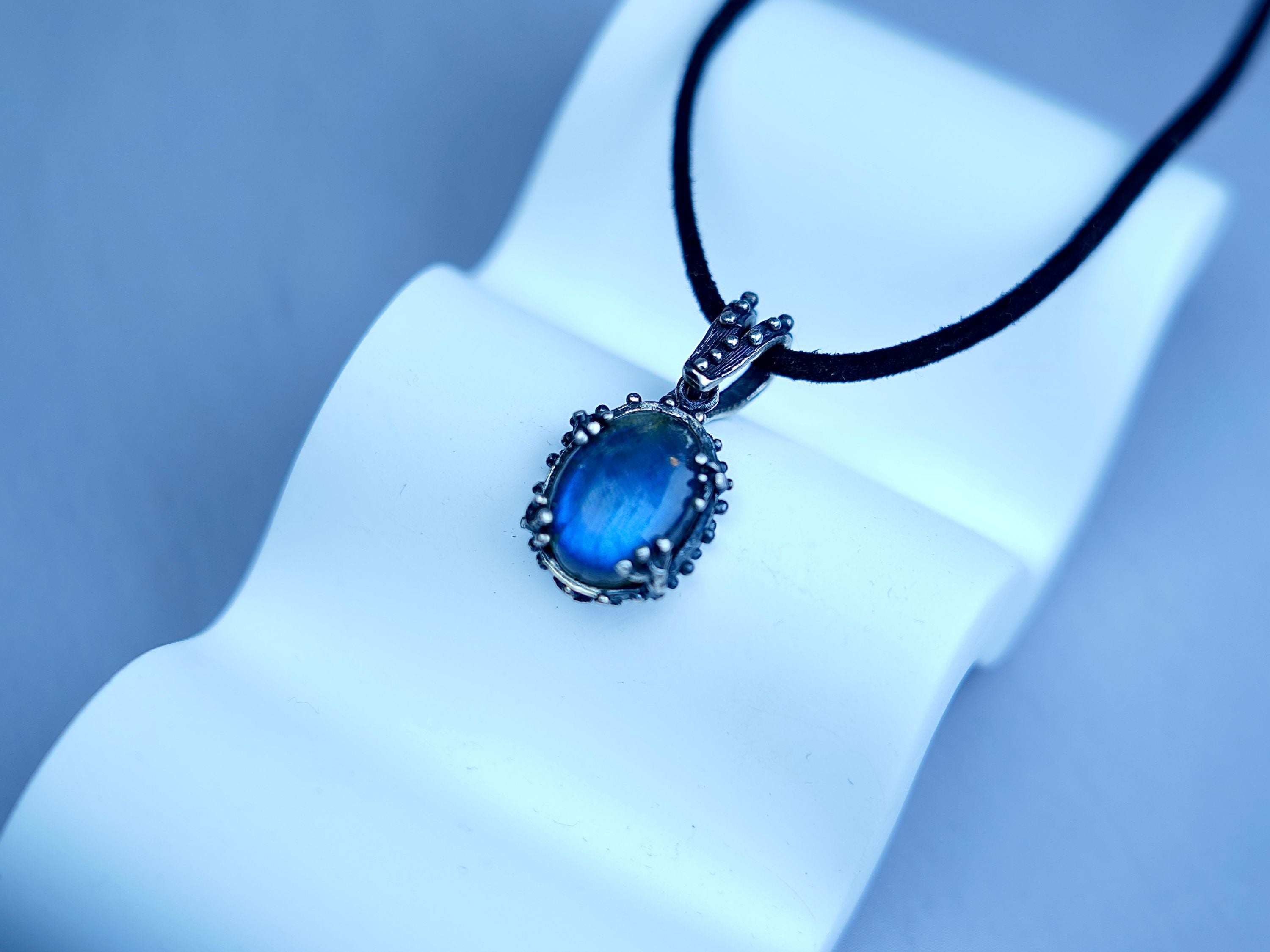 Angle view labradorite pendant blue flash gemstone silver necklace perspective