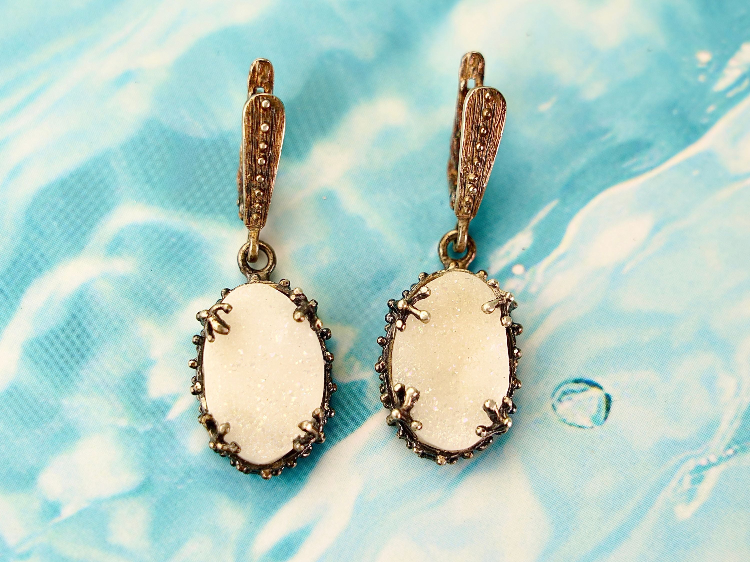 Angle view moonstone drop earrings glow stone silver dangle earrings perspective