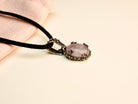 Rose quartz necklace angle view pink gemstone pendant elegant silver jewelry