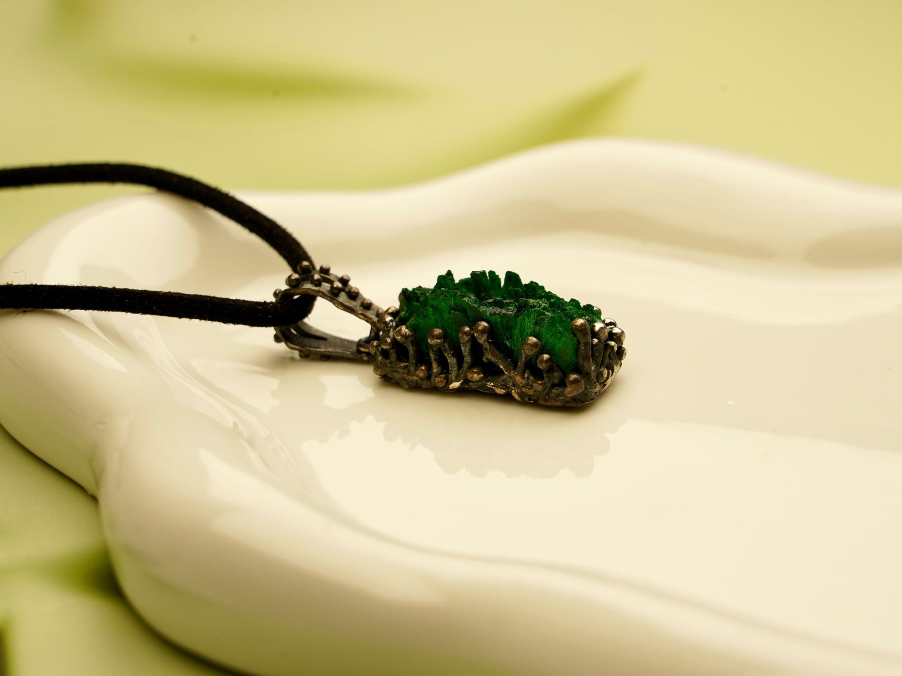 malachite pendant angle view raw green gemstone silver setting