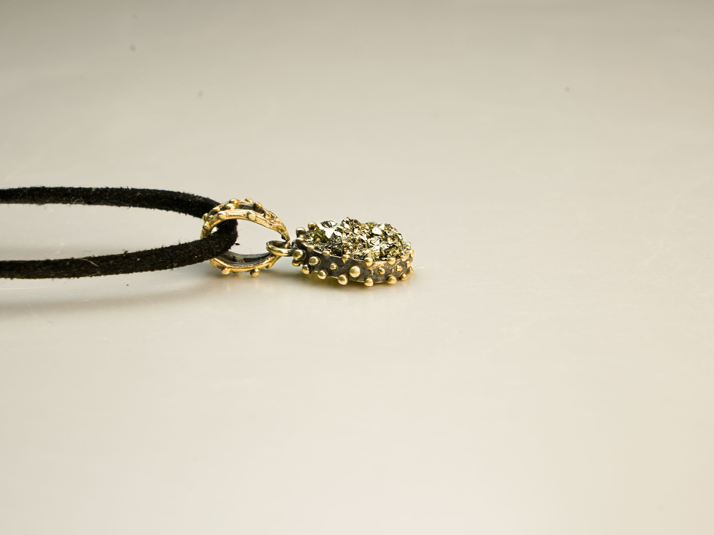 gold pyrite pendant angle view sterling silver handmade jewelry