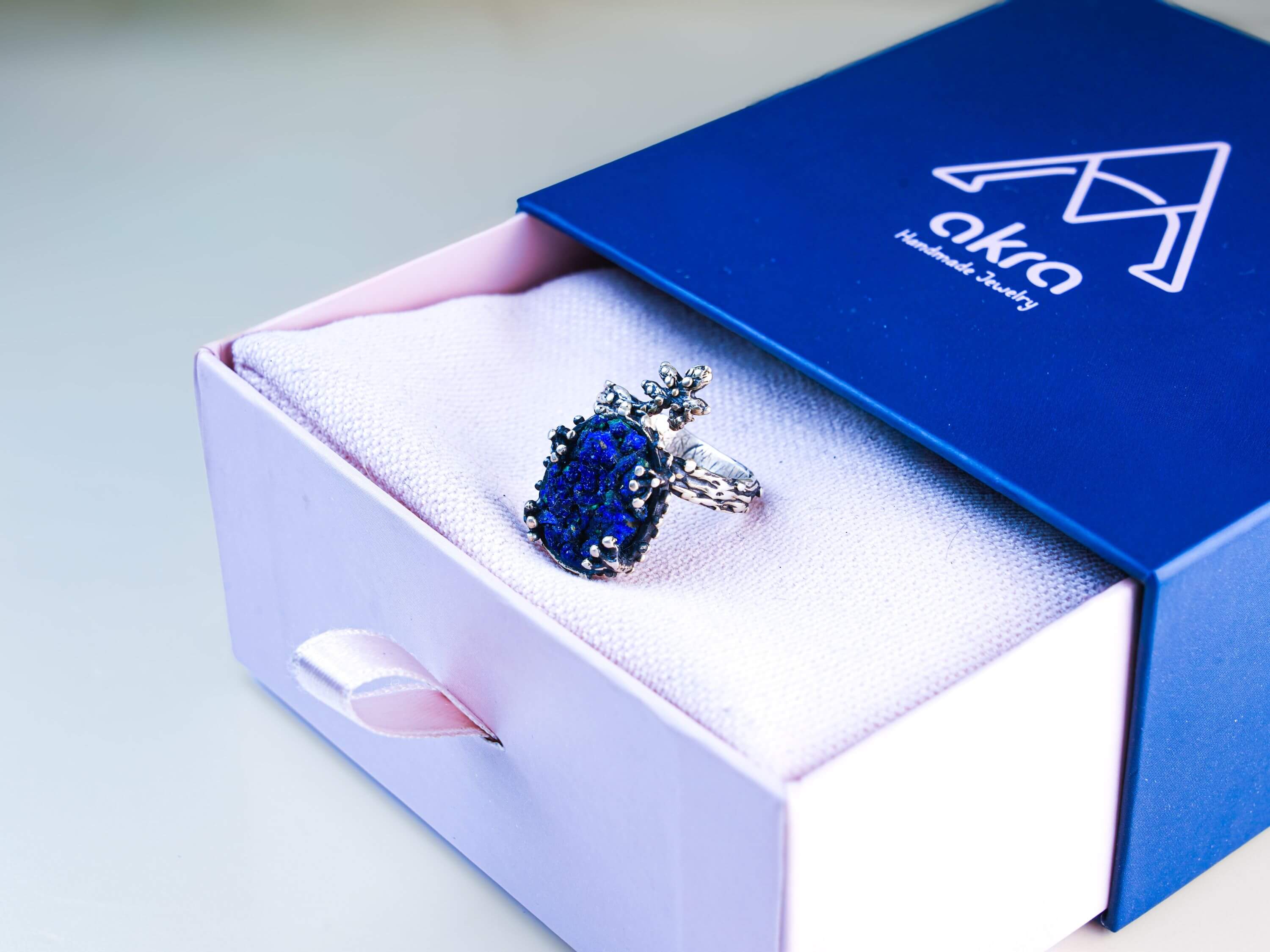 Lapis lazuli twig ring presented in Akra Gems signature blue and pink luxury jewelry box