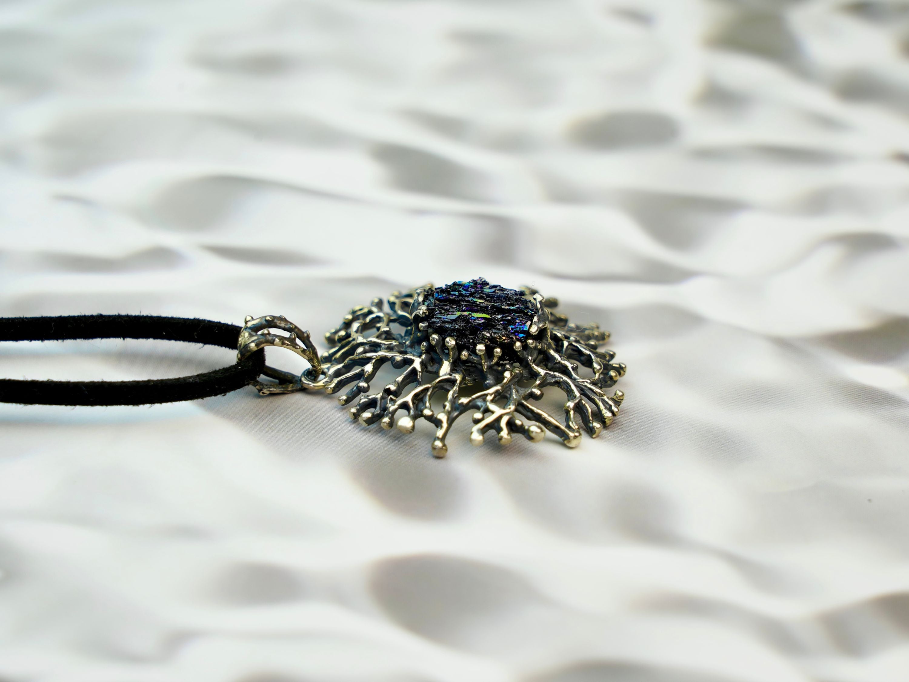 tourmaline pendant side profile, sculptural silver setting and crystal depth