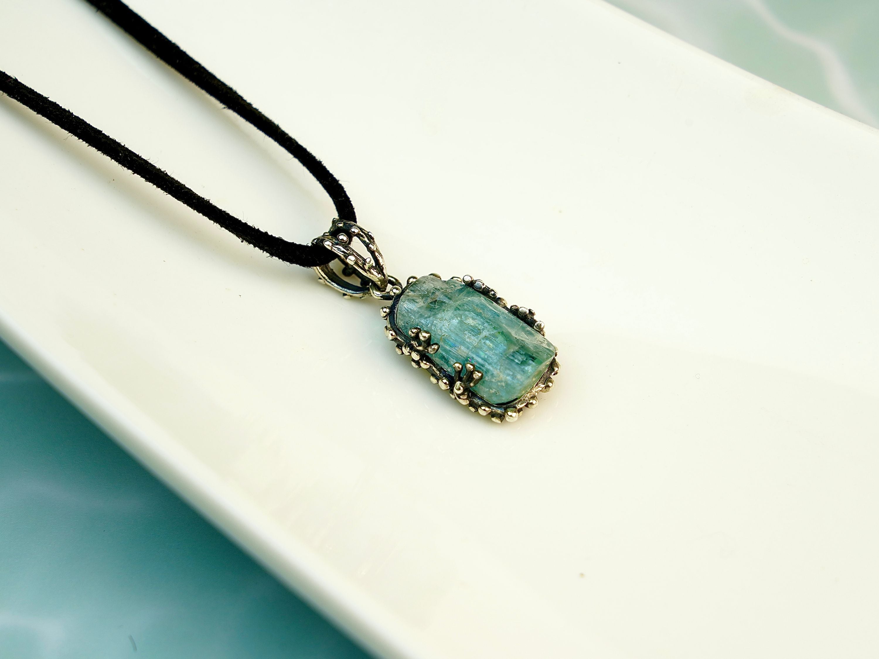 Side profile aquamarine pendant thickness sterling silver setting detail